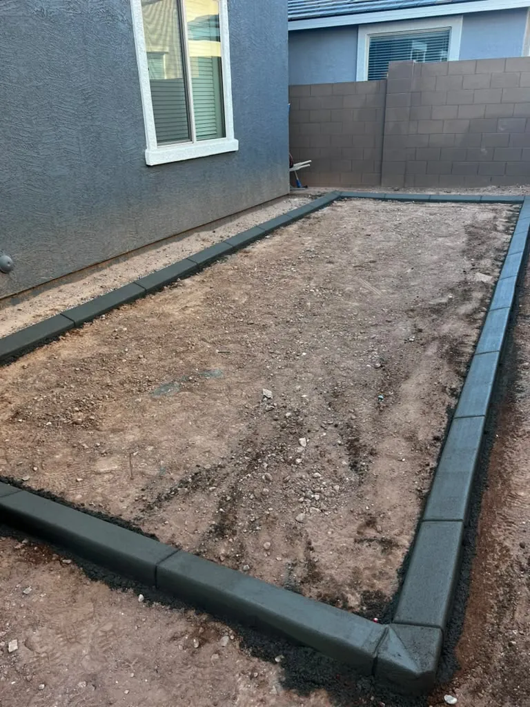 Planter bed edged with curbing, ready for planting.