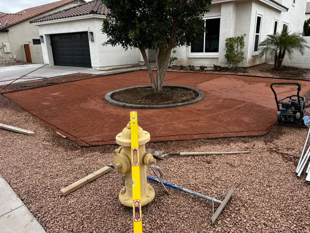 Front yard rebuilt with fresh decomposed granite around a shade tree