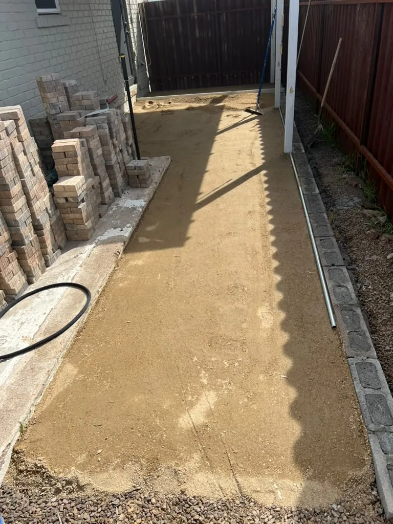 Paver walkway base screeded flat before the stone goes down