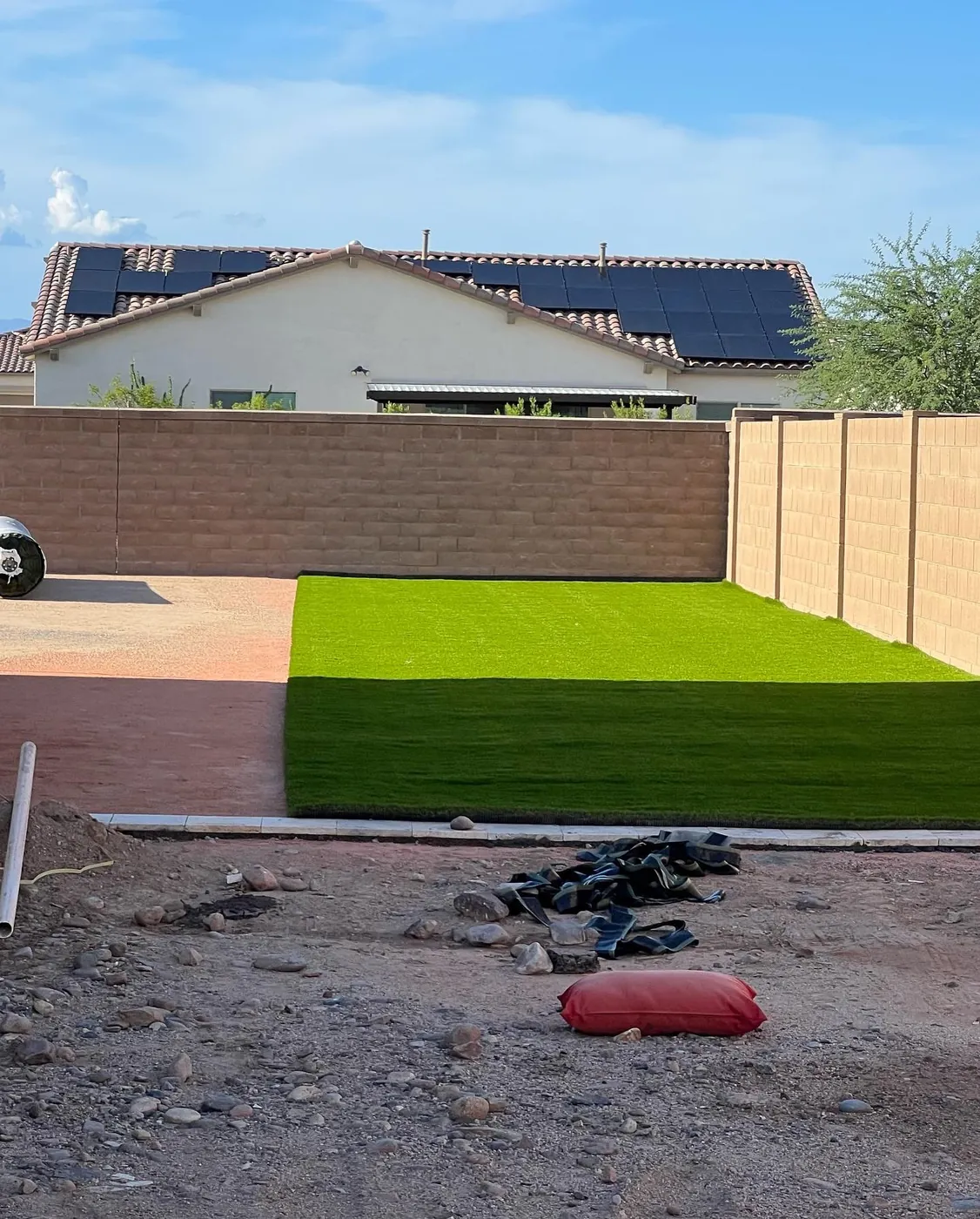 Synthetic grass laid tight to the block wall
