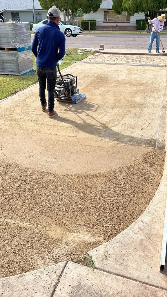 Pressure washing a driveway back to clean concrete