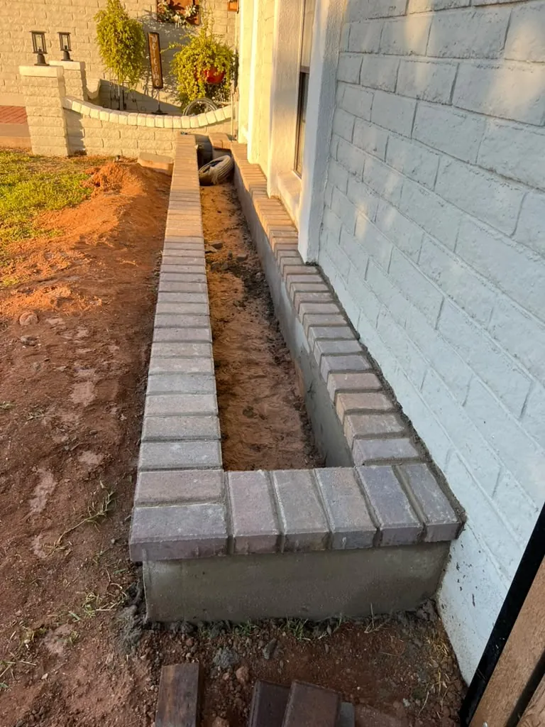 Block wall and paver walkway along the side yard